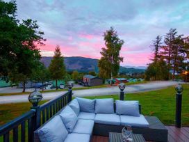 An outdoor seating area with a couch and trees at Dunoon 3Bed Lodge Sleeps 6 Pet Friendly near Dunoon