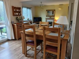 A dining room with a wooden table and chairs at Cosy 3 Bedroom House on Cornish estate with pool St Tudy