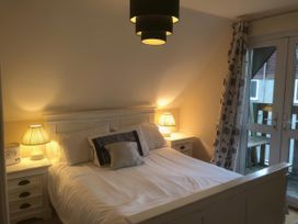A bedroom with a bed and bedside tables at Cosy 3 Bedroom House on Cornish estate with pool in St Tudy