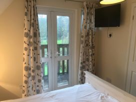 A bedroom with a bed and a television at Cosy 3 Bedroom House on Cornish estate with pool St Tudy