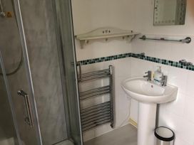 A bathroom with a shower cubicle and wash basin at Cosy 3 Bedroom House on Cornish estate with pool in St Tudy