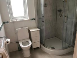 A bathroom with a toilet, shower and window at Cosy 3 Bedroom House on Cornish estate with pool St Tudy