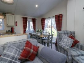 A living room with a sofa and dining area at Lakeland Lodge 3Bed 2 Bath Private Patio in Carnforth