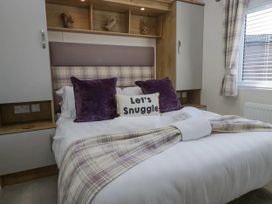 A bedroom with a bed and pillows at Lakeland Lodge 3Bed 2 Bath Private Patio in Carnforth