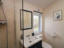 A bathroom with a shower, sink, and toilet at Lakeland Lodge 3Bed 2 Bath Private Patio in Carnforth