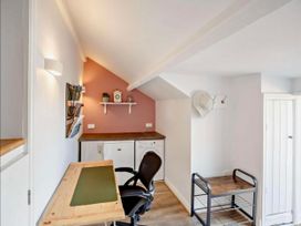 A home office with a desk and chair at Cottage Sleeps 5 with Parking and Garden, Carreglefn