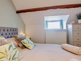A bedroom with a bed and dresser at Cottage Sleeps 5 with Parking and Garden in Carreglefn