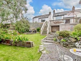 A garden with steps leading to a deck at Cottage Sleeps 5 with Parking and Garden in Carreglefn
