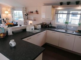 A kitchen with a sink and countertop at Seaside Lodge Retreat in Eyemouth
