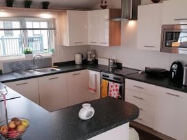 A kitchen with appliances and counter space at Seaside Lodge Retreat in Eyemouth