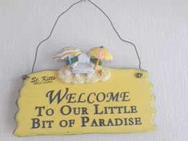 A decorative sign with welcome message at Seaside Lodge Retreat in Eyemouth