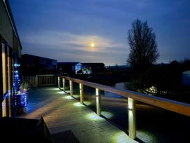 An outdoor space with decking and railings near water at Malton 2Bed Lodge Sleeps 4 Pet Friendly, Malton