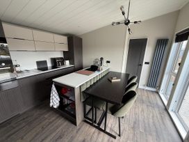 A kitchen with cabinets and dining area at Malton 2Bed Lodge Sleeps 4 Pet Friendly in Malton