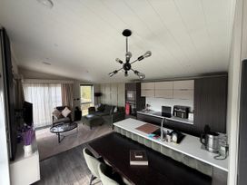 A living room with a sofa, coffee table, and kitchen area at Malton 2Bed Lodge Sleeps 4 Pet Friendly in Malton