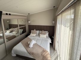 A bedroom with a bed and a mirror at Malton 2Bed Lodge Sleeps 4 Pet Friendly in Malton