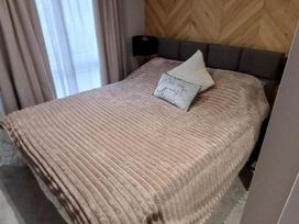 A bed with a blanket and pillows in Malton 2Bed Lodge Sleeps 4 Pet Friendly, Malton
