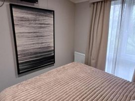 A bedroom with a bed and a painting at Malton 2Bed Lodge Sleeps 4 Pet Friendly in Malton