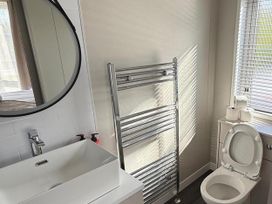 A bathroom with a sink, toilet, and towel rail at Malton 2Bed Lodge Sleeps 4 Pet Friendly in Malton