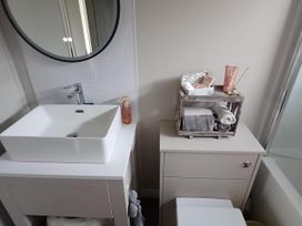 A bathroom with a sink and storage container at Malton 2Bed Lodge Sleeps 4 Pet Friendly, Malton
