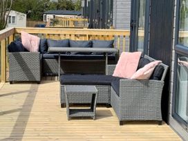 A deck with seating and a table at Malton 2Bed Lodge Sleeps 4 Pet Friendly in Malton
