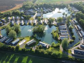 A view of lodges around a lake at Malton 2Bed Lodge Sleeps 4 Pet Friendly in Malton