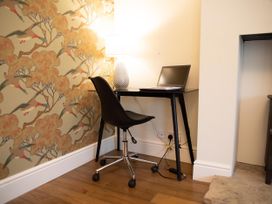 An office setup with a desk and chair at York Minster 3bed Sleeps 6 Fireplace Free Parking, York