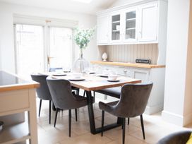 A dining room with a table set for six at York Minster 3bed Sleeps 6 Fireplace Free Parking, York