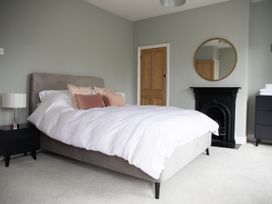 A bedroom with a bed and nightstand at York Minster 3bed Sleeps 6 Fireplace Free Parking, York