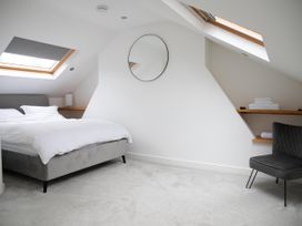A bedroom with a bed and a chair at York Minster 3bed Sleeps 6 Fireplace Free Parking, York