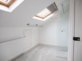 A bathroom with skylights and a glass shower partition at York Minster 3bed Sleeps 6 Fireplace Free Parking, York