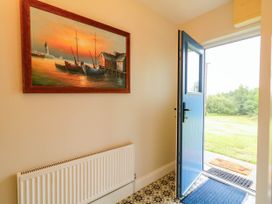 An entryway with a painting and front door at Biddy Granny's