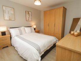 A bedroom with a double bed and two side tables at Biddy Granny's 