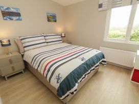 A bedroom with a bed and nightstands at Biddy Granny's 