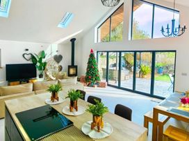A living room with a Christmas tree and large windows at 4 Bed Villa Sleeps 8 Private Terrace Free parking near St Austell
