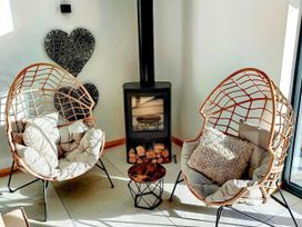 A living room with chairs and a fireplace at 4 Bed Villa Sleeps 8 Private Terrace Free parking near St Austell