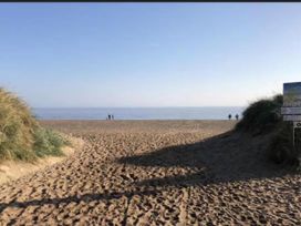 A beach scene with sand and sea at Sandy Paws Dog Friendly Anderby Creek