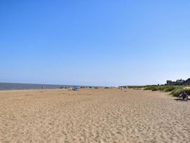 A beach with sand and sea at Sandy Paws Dog Friendly Anderby Creek