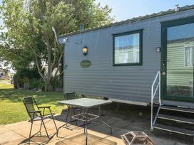 An outdoor area with a caravan and seating at 3 Bed Caravan Sleeps 8 Pets Garden Parking in Hull