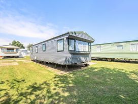 A caravan in a grassy area at 3 Bed Caravan Sleeps 8 Pets Garden Parking in Hull