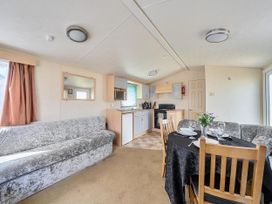 A living room with a sofa and dining table at 3 Bed Caravan Sleeps 8 Pets Garden Parking, Hull