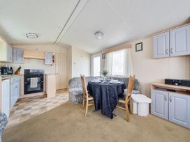 A living room with a table and chairs at 3 Bed Caravan Sleeps 8 Pets Garden Parking in Hull
