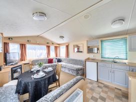A living room with a dining table and sofa at 3 Bed Caravan Sleeps 8 Pets Garden Parking in Hull