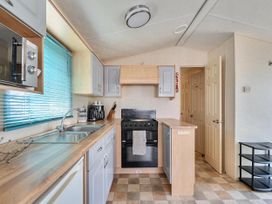 A kitchen with countertop and appliances at 3 Bed Caravan Sleeps 8 Pets Garden Parking in Hull
