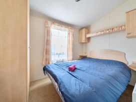 A bedroom with a bed and wardrobe at 3 Bed Caravan Sleeps 8 Pets Garden Parking in Hull