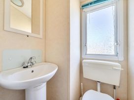 A sink and toilet in a bathroom at 3 Bed Caravan Sleeps 8 Pets Garden Parking Hull