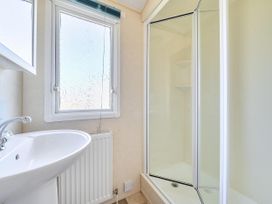 A bathroom with a sink and shower at 3 Bed Caravan Sleeps 8 Pets Garden Parking Hull