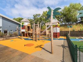 A playground with a play structure and slide at a play area