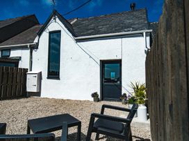 An outdoor area with gravel and chairs at The Milking Shed at Pencraig Pet Friendly, Llanynghenedl near Holyhead