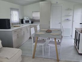 A kitchen with a table and chairs at Luxury Cosy Caravan in Cresswell Northumberland