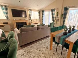 A living room with a sofa and television at the property in location
